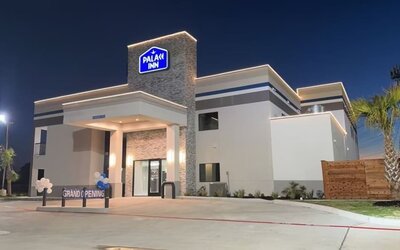 Hotel exterior at night at Palace Inn Blue Jones Rd. 