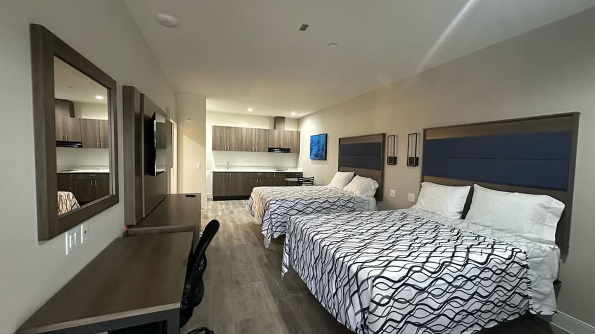 Spacious day room with kitchen area and work station at Palace Inn Blue Jones Rd. 