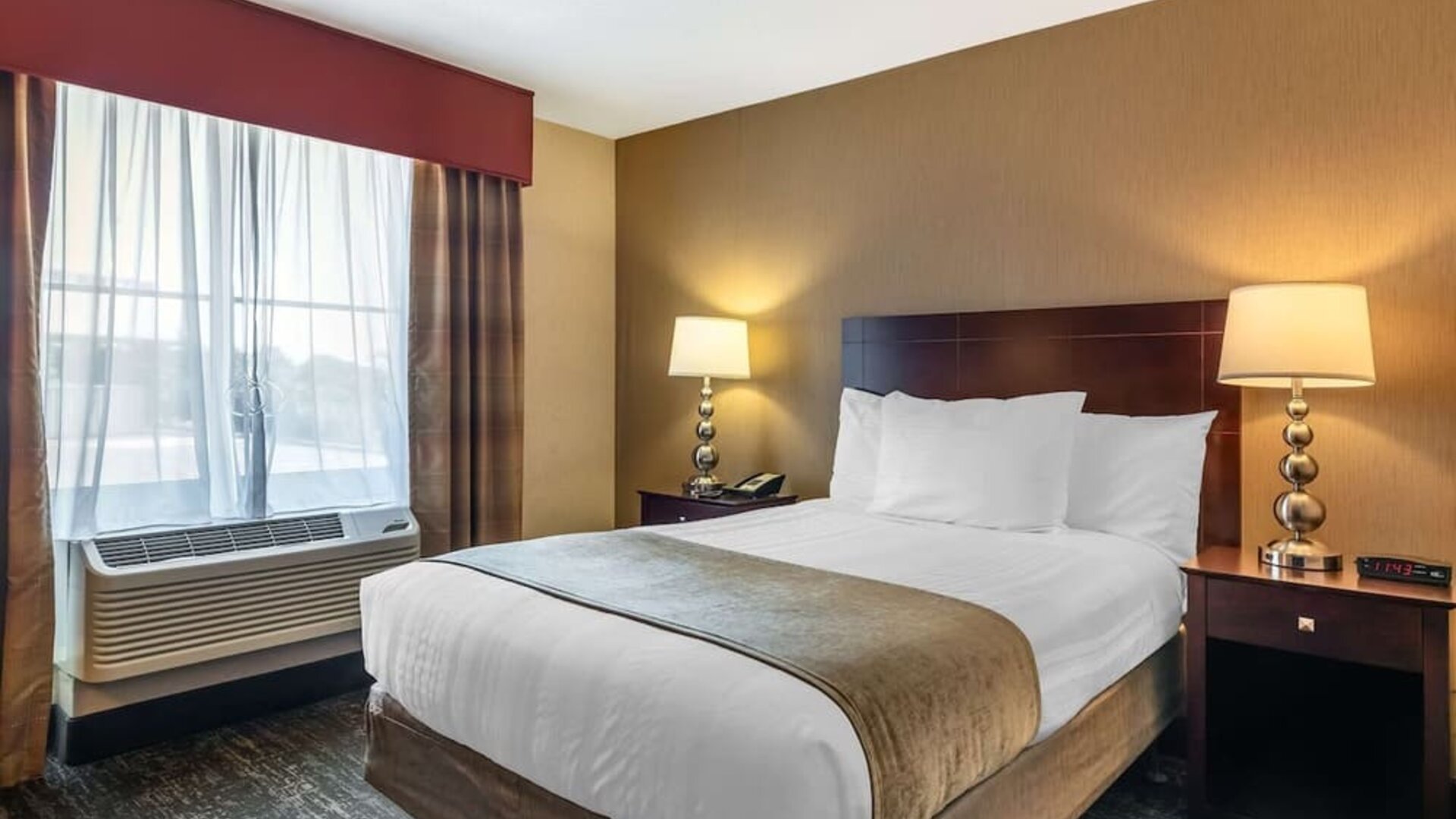 Comfortable king guest room featuring plush bedding, modern furnishings, and convenient in-room amenities at Best Western Braintree.