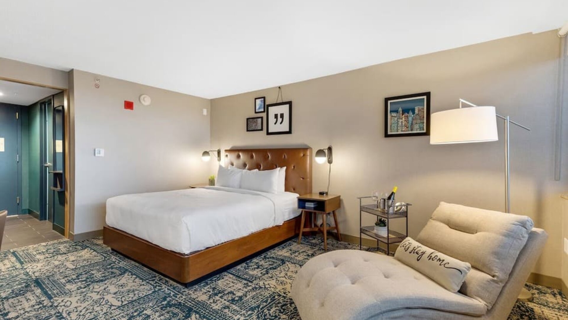 Spacious king guest room featuring a comfortable seating area, modern amenities, and contemporary décor at Four Points by Sheraton Boston-Newton.