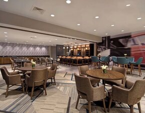 Stylish dining area with comfortable seating, modern décor, and ample space for breakfast, lunch, or evening dining at Four Points by Sheraton Boston-Newton.