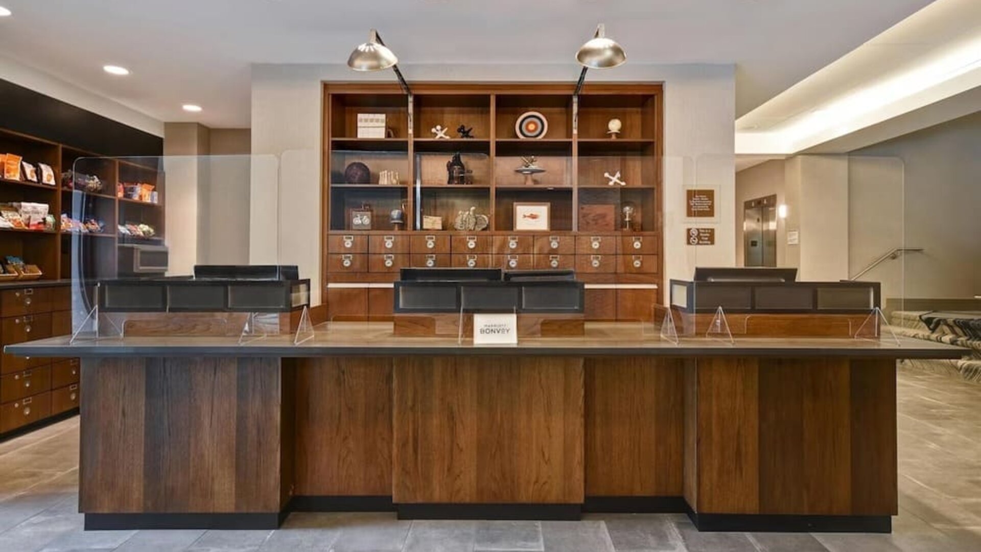 Modern reception desk providing welcoming guest services and efficient check-in experiences at Four Points by Sheraton Boston-Newton.