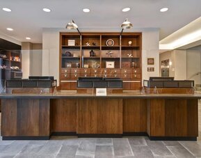 Modern reception desk providing welcoming guest services and efficient check-in experiences at Four Points by Sheraton Boston-Newton.
