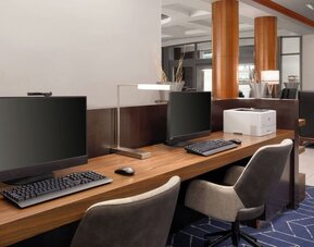 Business center featuring computer workstations and printing capabilities for guest productivity and convenience at Courtyard by Marriott Boston Brookline.