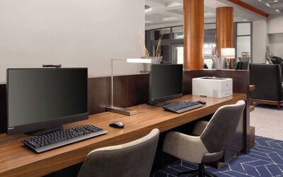 Business center featuring computer workstations and printing capabilities for guest productivity and convenience at Courtyard by Marriott Boston Brookline.