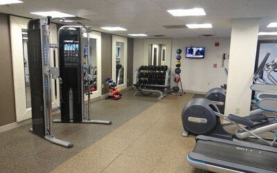 Fitness center equipped with cardio machines, free weights, and strength-training equipment to support guests’ wellness routines at DoubleTree by Hilton Westborough.