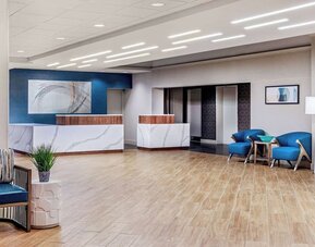 Contemporary hotel lobby with elegant reception desks, modern seating, and a welcoming arrival experience at DoubleTree by Hilton Westborough.