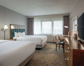 Double queen guest room featuring premium bedding, a dedicated workspace, and comfortable accommodations for business and leisure travelers at DoubleTree by Hilton Westborough.