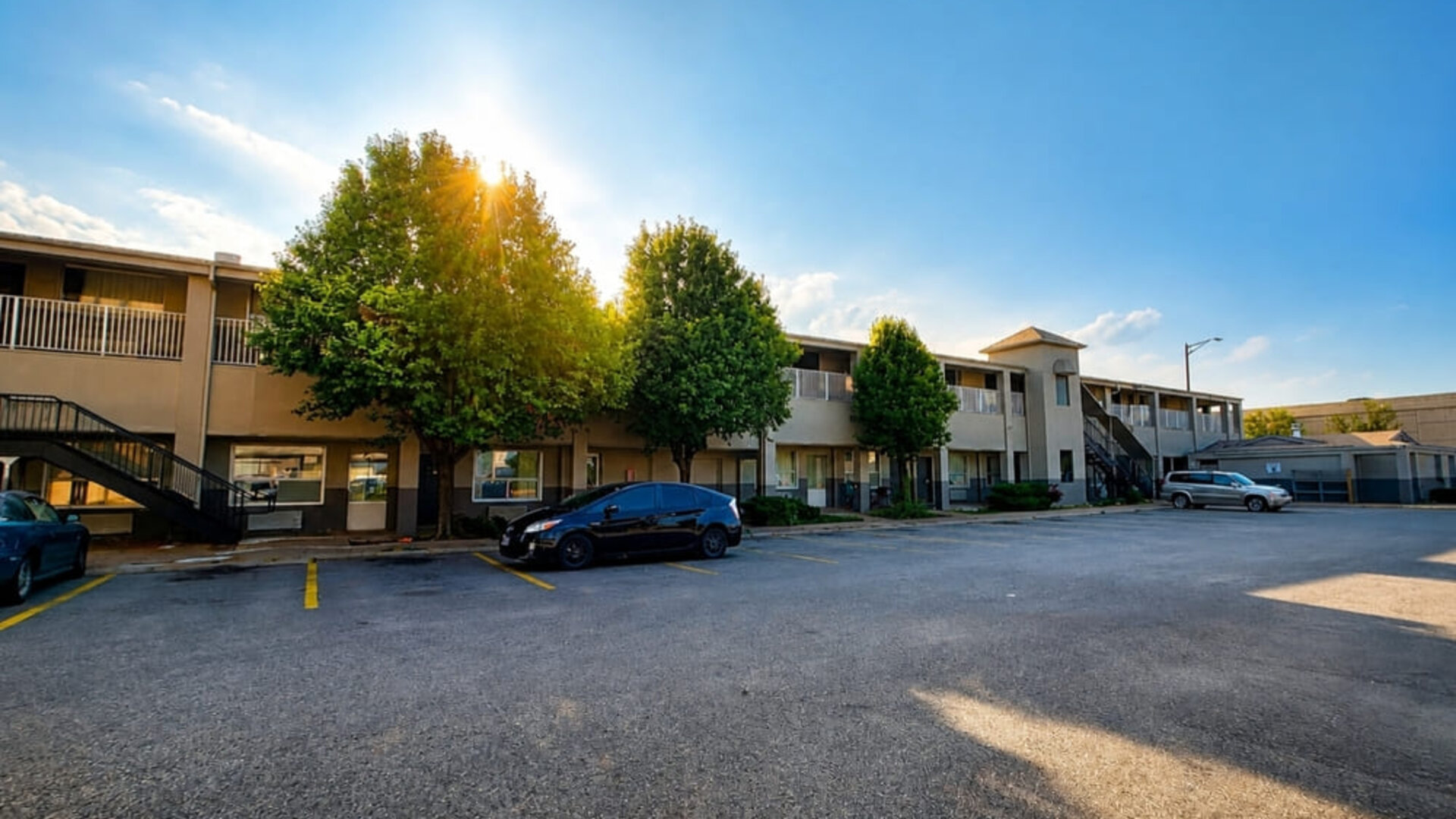Exterior view of the hotel showcasing convenient parking, easy room access, and a welcoming setting for travelers visiting Wichita at Blue Way Inn & Suites Wichita East.