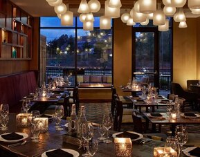 Elegant hotel restaurant featuring contemporary décor, comfortable seating, and a welcoming ambiance for dining and social gatherings at Hilton Garden Inn Boston/Marlborough.
