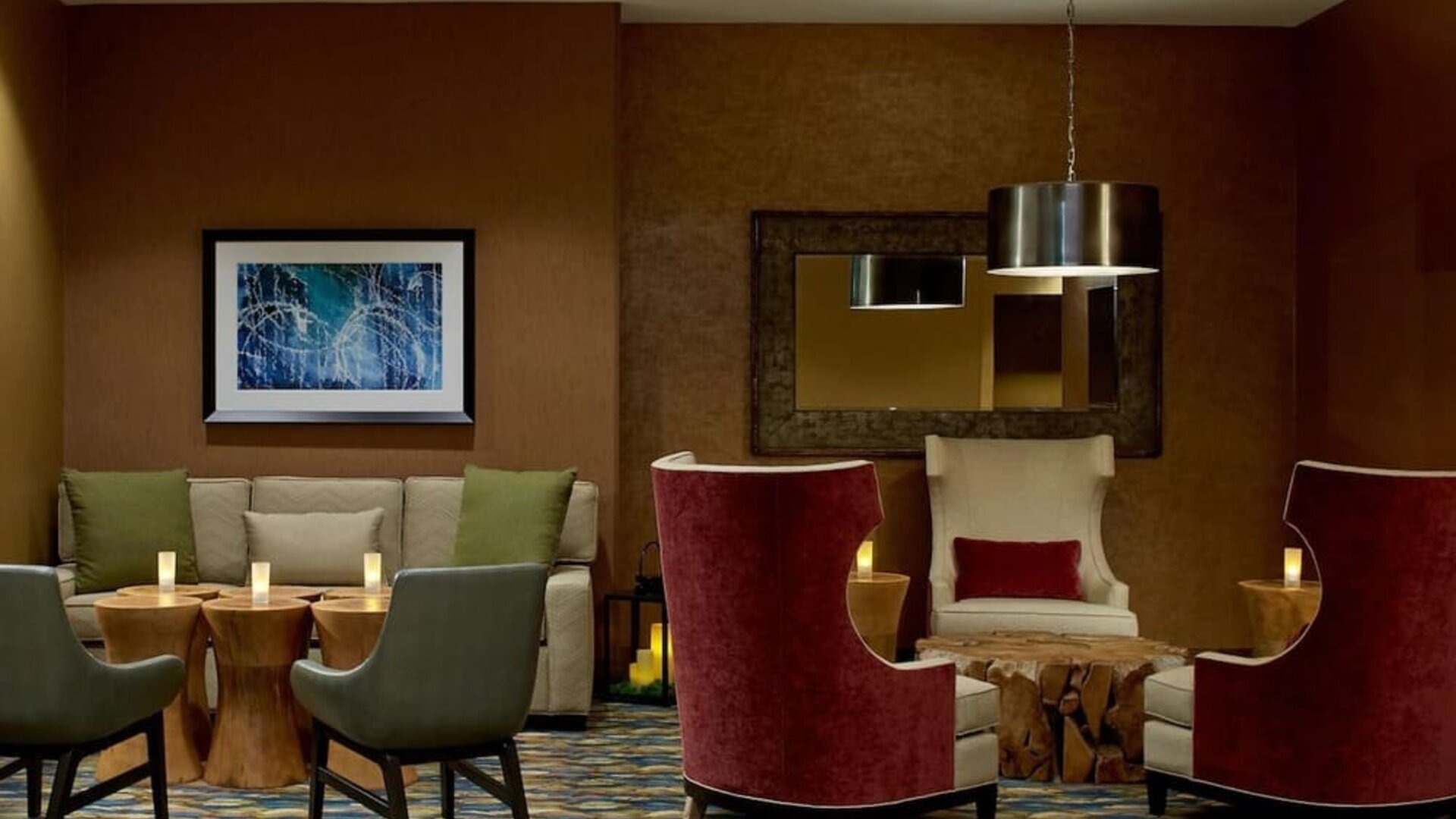 Inviting lounge area featuring comfortable seating, warm décor, and intimate gathering spaces perfect for relaxing or meeting with colleagues at Hilton Garden Inn Boston/Marlborough.