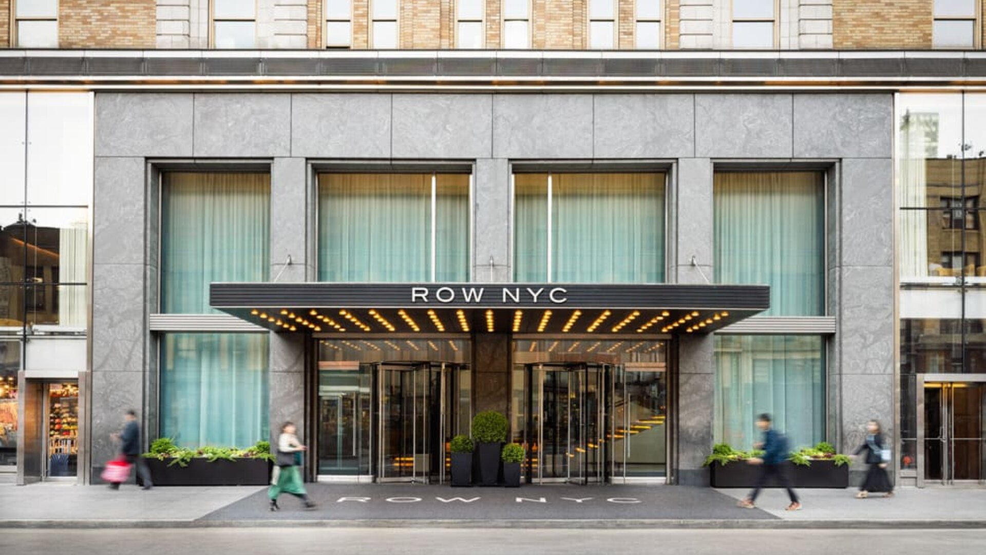 Main entrance of Row NYC featuring a contemporary façade, elegant lighting, and a welcoming arrival experience in the heart of New York City.