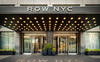 Close-up view of the iconic Row NYC entrance showcasing contemporary design, illuminated canopy lighting, and stylish curb appeal.