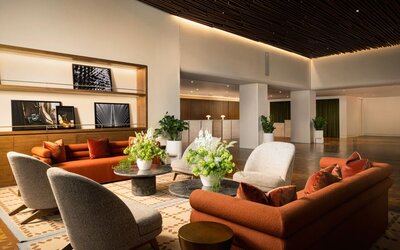 Inviting lounge area featuring contemporary furnishings, warm décor, and comfortable seating spaces for relaxation and socializing at Row NYC.