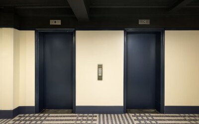 Elevator lobby featuring convenient guest access, modern finishes, and efficient transportation throughout Row NYC.