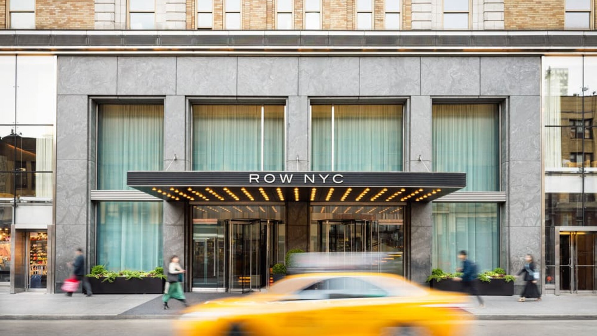 Main entrance of Row NYC featuring a contemporary façade, elegant lighting, and a welcoming arrival experience in the heart of New York City.