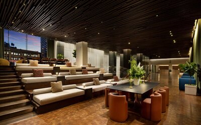Elegant lobby area featuring contemporary décor, comfortable seating, and open spaces designed for relaxation and social interaction at Row NYC.