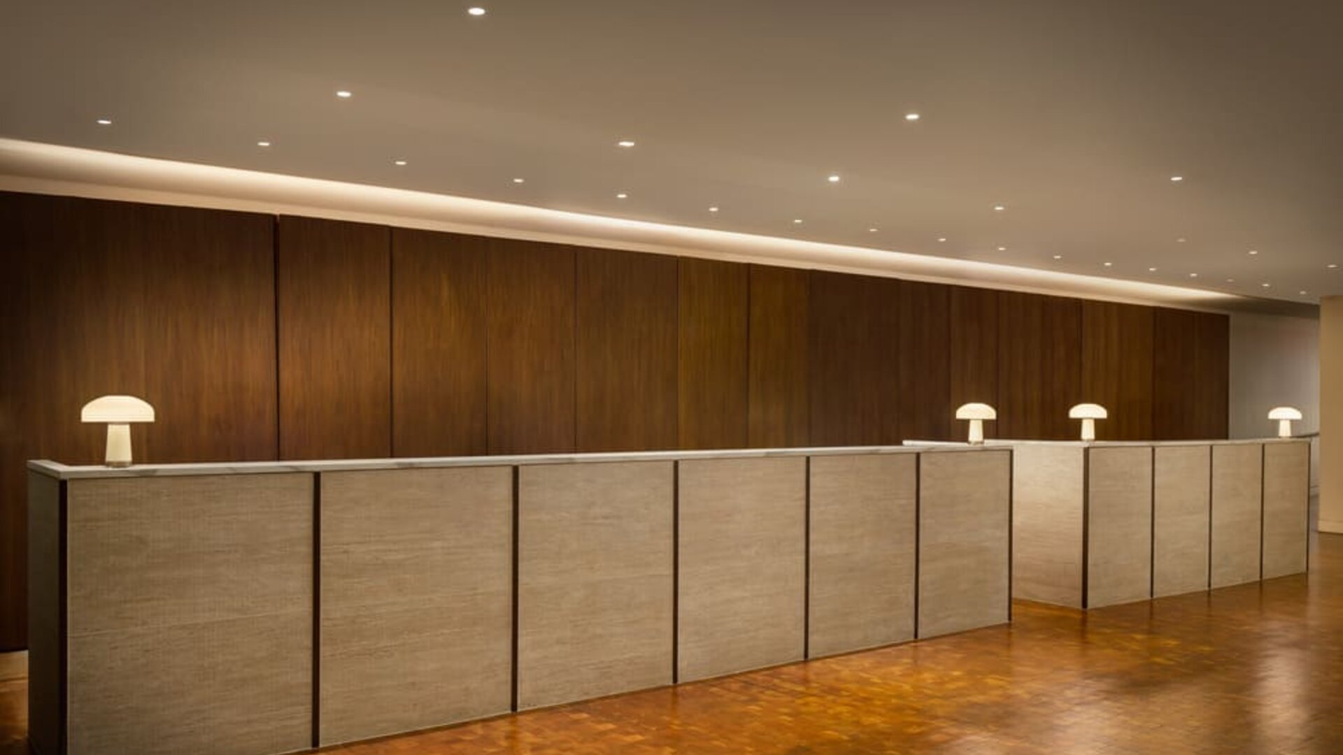 Modern reception desk featuring streamlined check-in services, contemporary design, and a welcoming atmosphere for guests arriving at Row NYC.