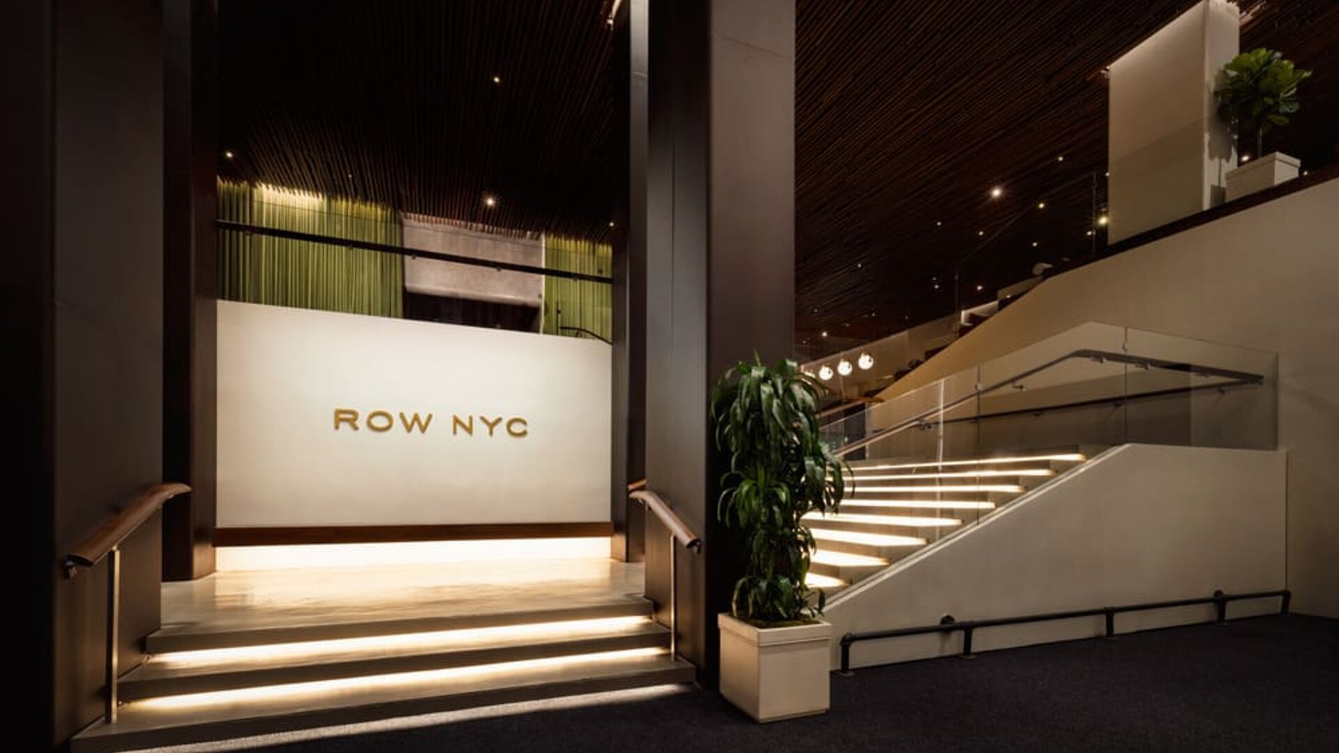 Interior stairway showcasing modern design, illuminated steps, and sophisticated architectural details within Row NYC.