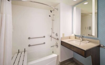 Guest bathroom with shower at Hilton Garden Inn IAH Houston.
