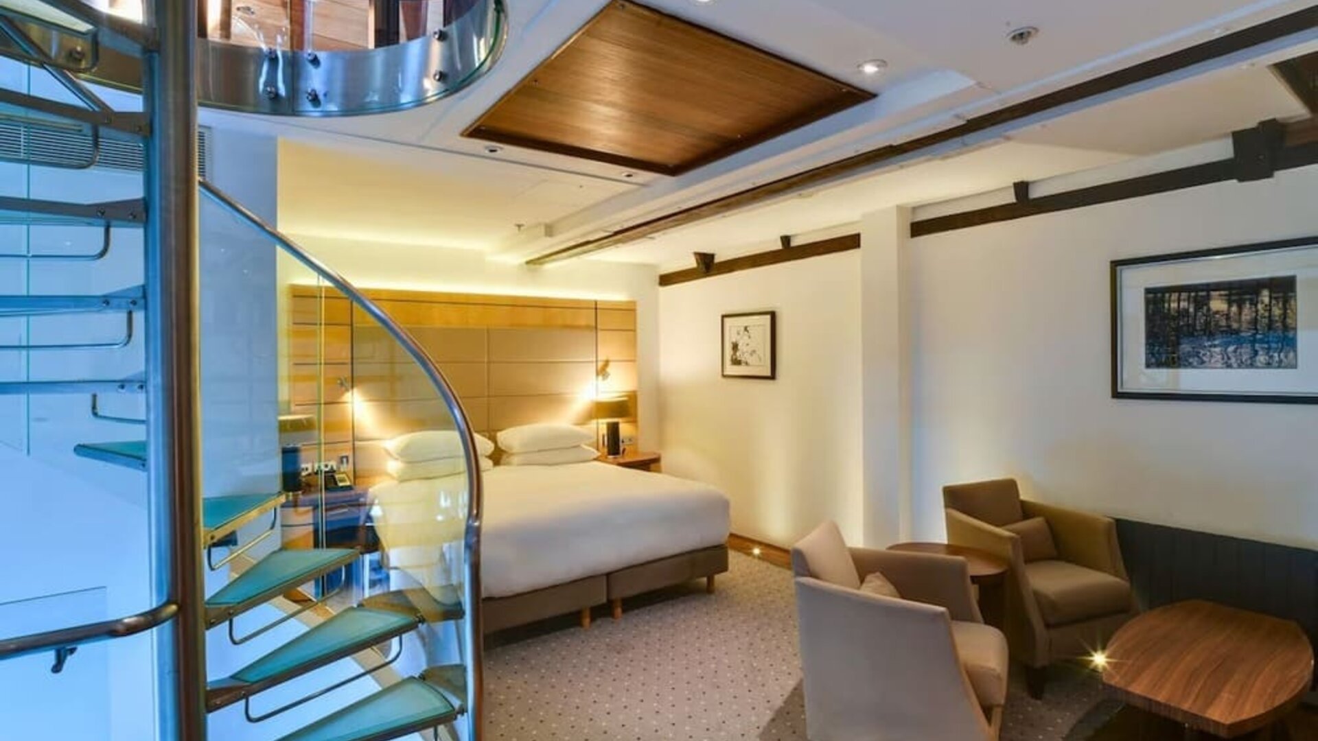 Day use room with sofa chairs and table at Hilton London Paddington.