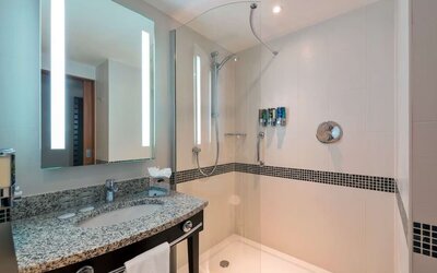 Guest bathroom with shower at Hampton By Hilton London Luton Airport.