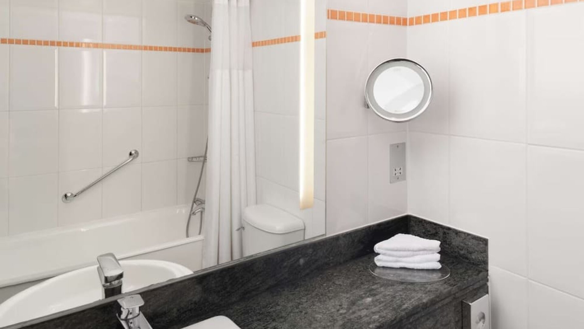 Guest bathroom with shower at Hilton London Kensington.
