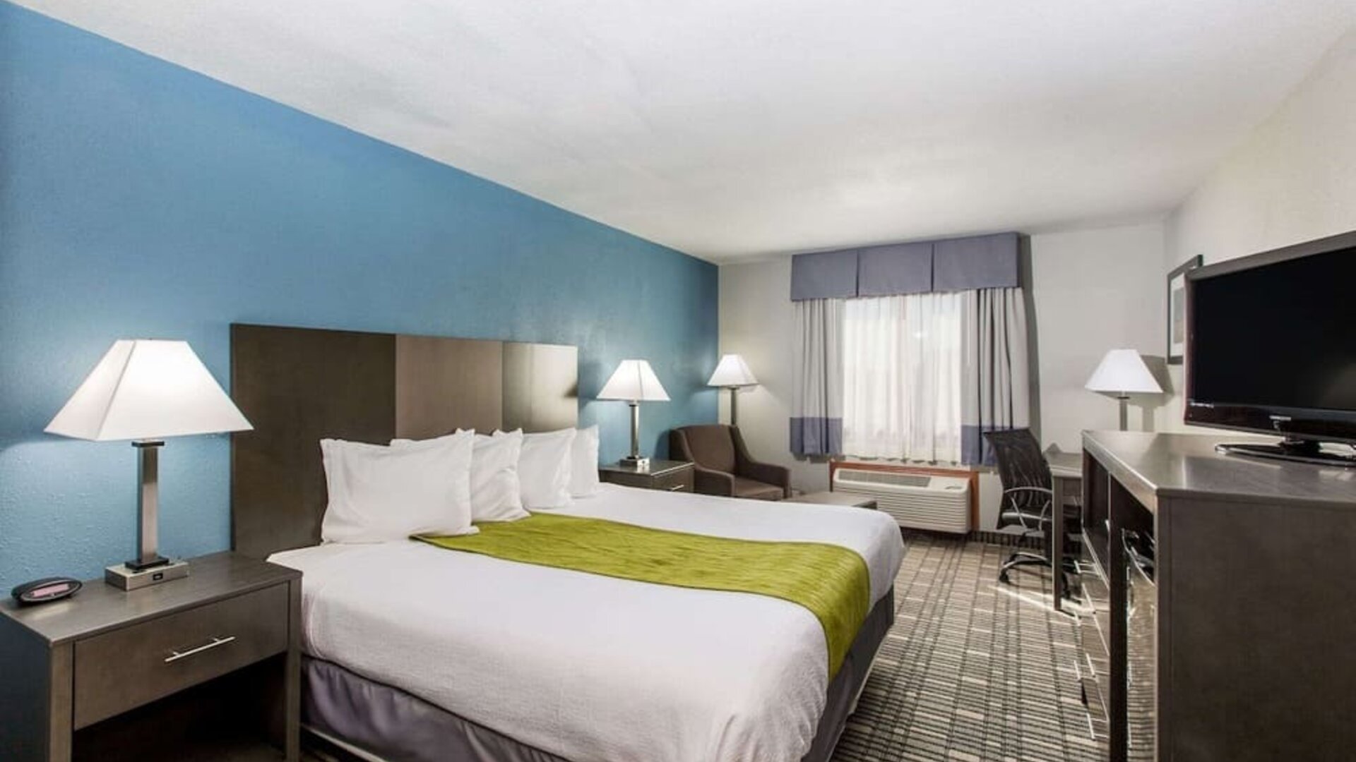 Romantic king room with TV at Baymont By Wyndham Pella.