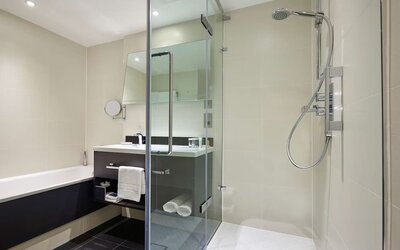 Guest bathroom with shower at Hilton London Heathrow Airport.