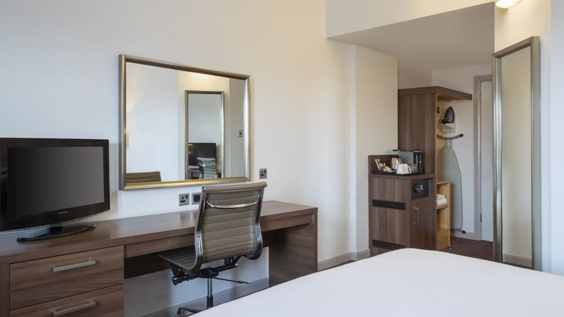 Day use room with work desk, coffee maker and cabinet at Leonardo Hotel Leeds.