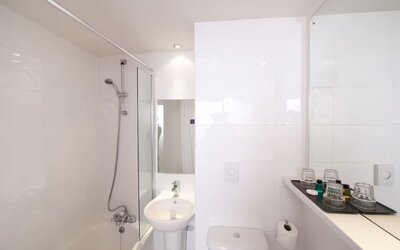 Guest bathroom with shower at Leonardo Inn Glasgow West End. 