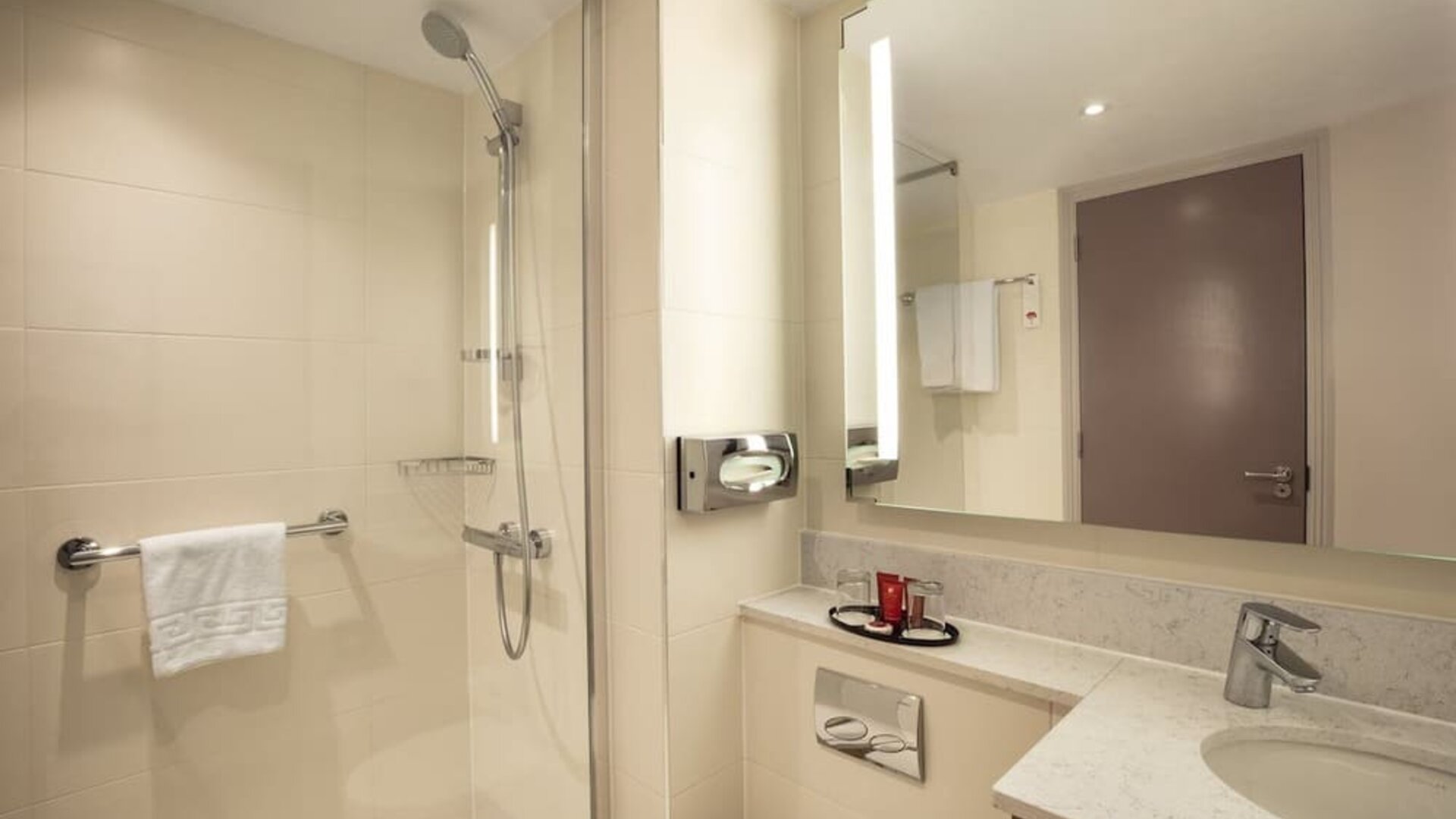 Guest bathroom with shower at Leonardo Hotel London Heathrow Airport.