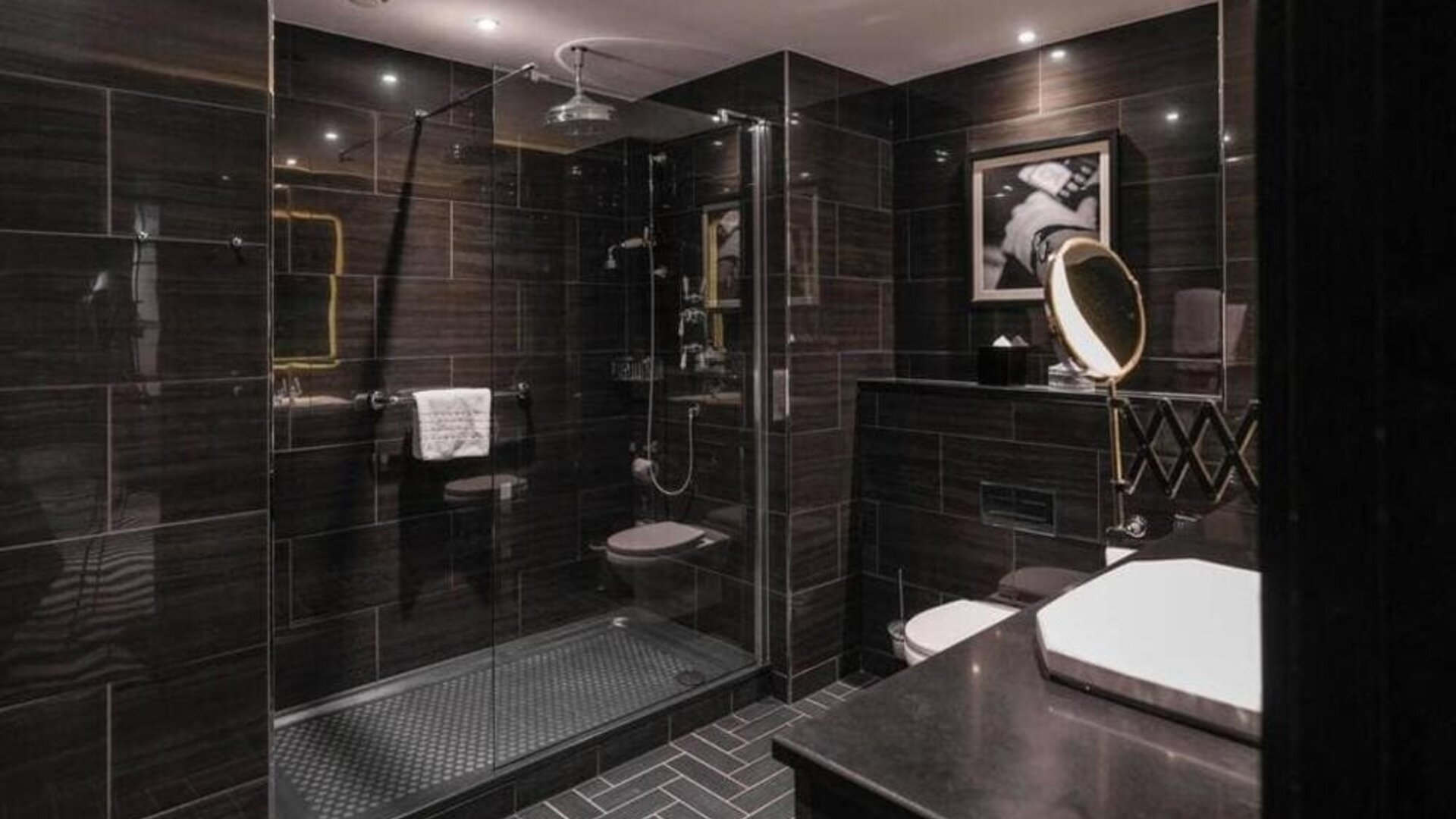 Guest bathroom with shower at Hotel Gotham.  