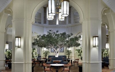 Bright lobby with arches and greeneries at The Midland - A Leonardo Royal Hotel.  