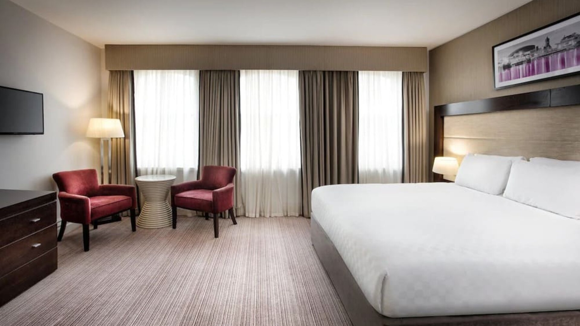 King bed with TV at Leonardo Hotel Cardiff.