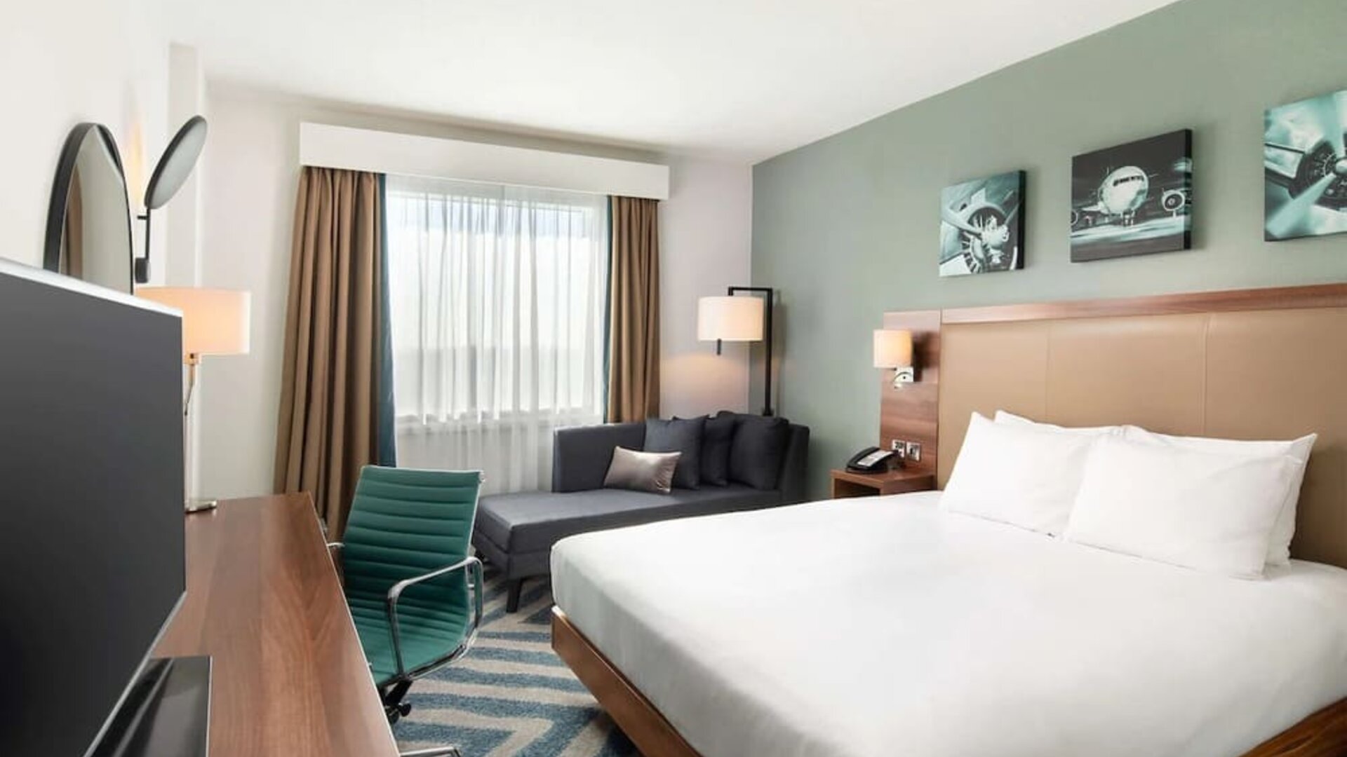 Comfortable delux king room with TV and work desk at Hilton Garden Inn London Heathrow Airport.