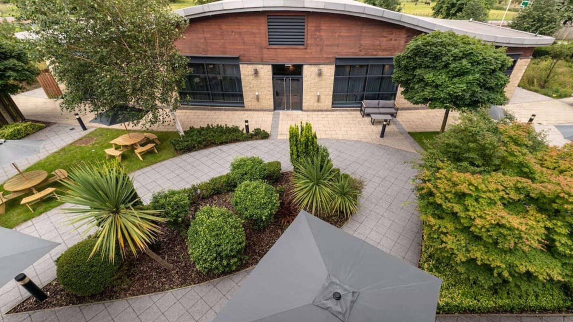 Seats and table available in the garden at Hilton Garden Inn London Heathrow Airport.