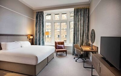 King bedroom with large window at Hilton Edinburgh Carlton.