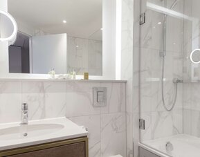 Guest bathroom with shower and tub at DoubleTree By Hilton Stoke On Trent.
