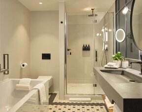 Guest bathroom with shower and tub at The Gantry London, Curio Collection By Hilton.