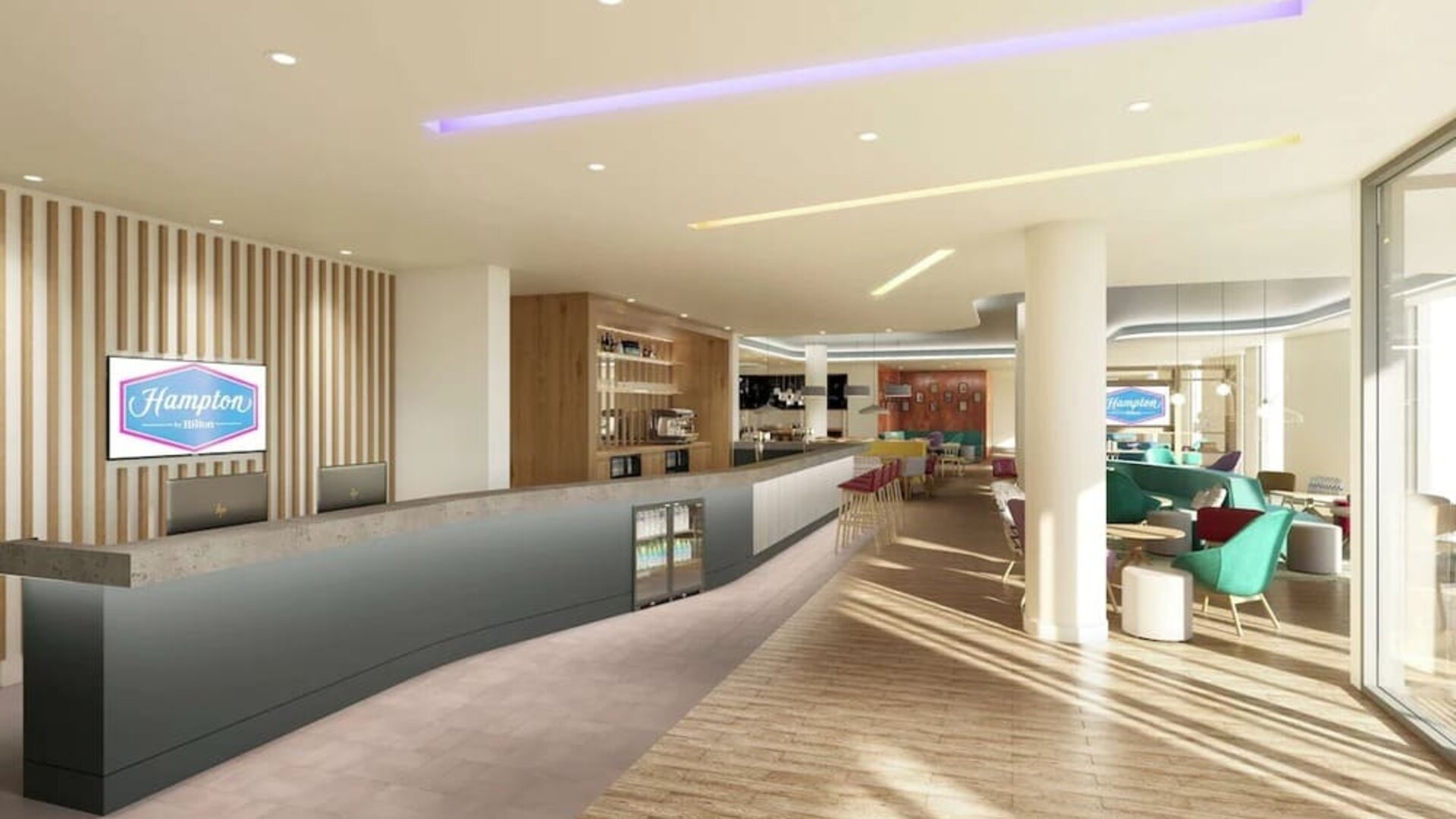 Bright lobby with lounge area at the Hampton by Hilton Manchester Northern Quarter.