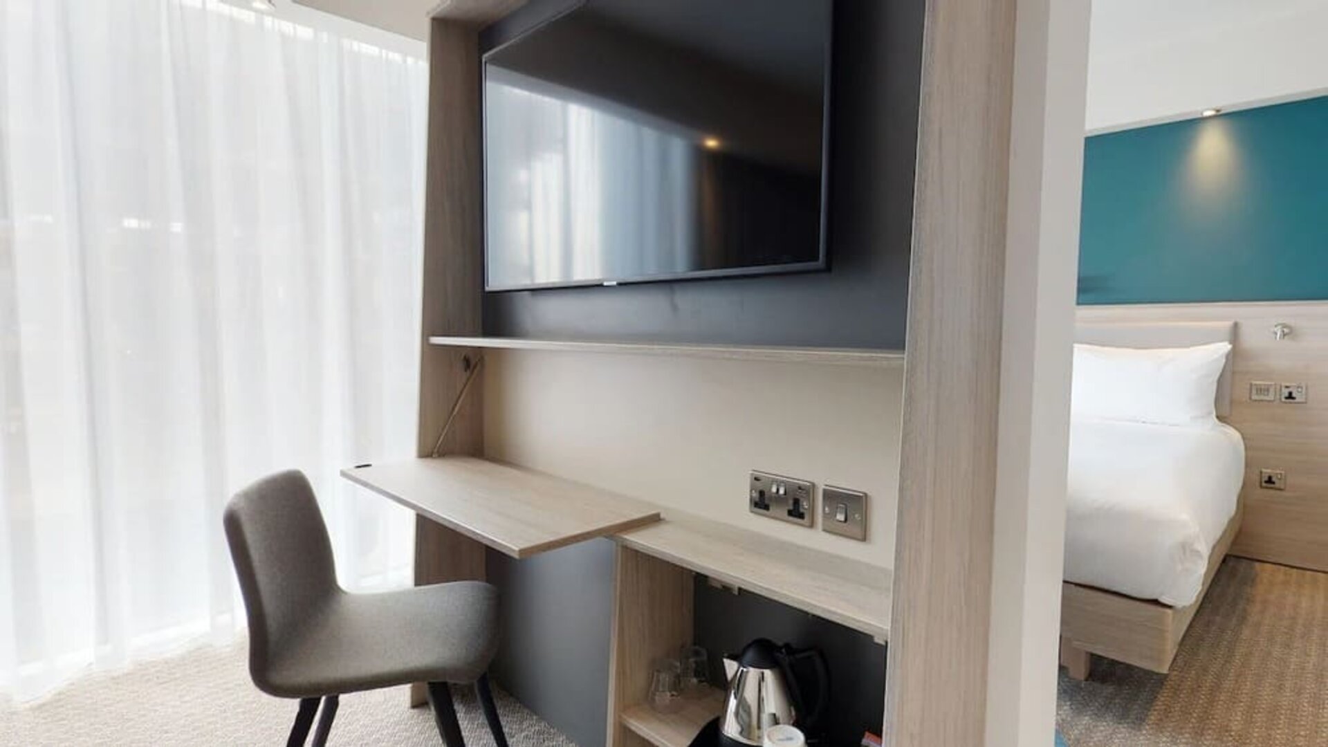 Day use room with living room, TV and work desk at the Hampton by Hilton Manchester Northern Quarter.