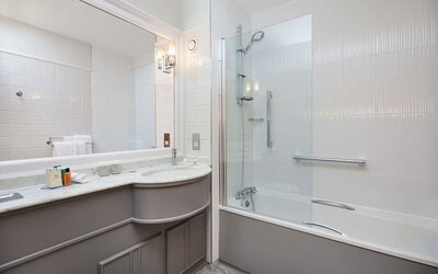 Guest bathroom with shower and tub at DoubleTree By Hilton Coventry.