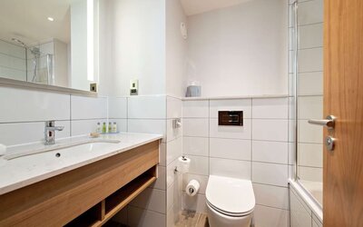 Guest bathroom with shower and tub at Hilton Garden Inn Abingdon Oxford.