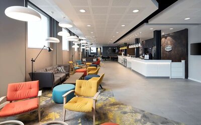 Spacious hotel lobby with lounge area, perfect for co-working at the Hampton by Hilton London Docklands.