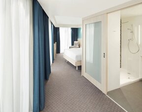 Bright day use room with TV, sofa and private bathroom at the Hampton by Hilton London Docklands.