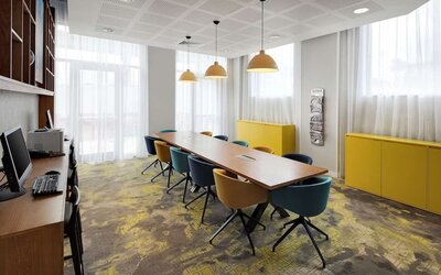 Business center with table, computer and printer at the Hampton by Hilton London Docklands.