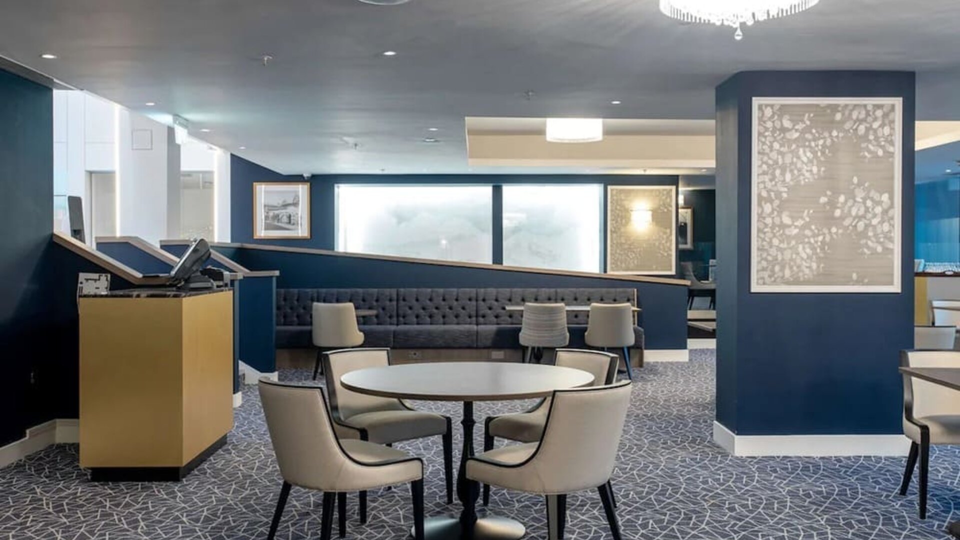 Hotel restaurant with comfortable chairs, perfect for co-working at the Hilton London Gatwick Airport.