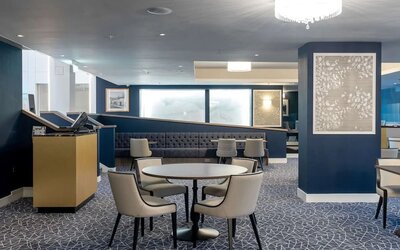 Hotel restaurant with comfortable chairs, perfect for co-working at the Hilton London Gatwick Airport.