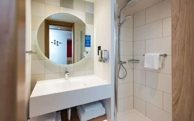 Guest bathroom with shower at Hampton By Hilton London Park Royal.